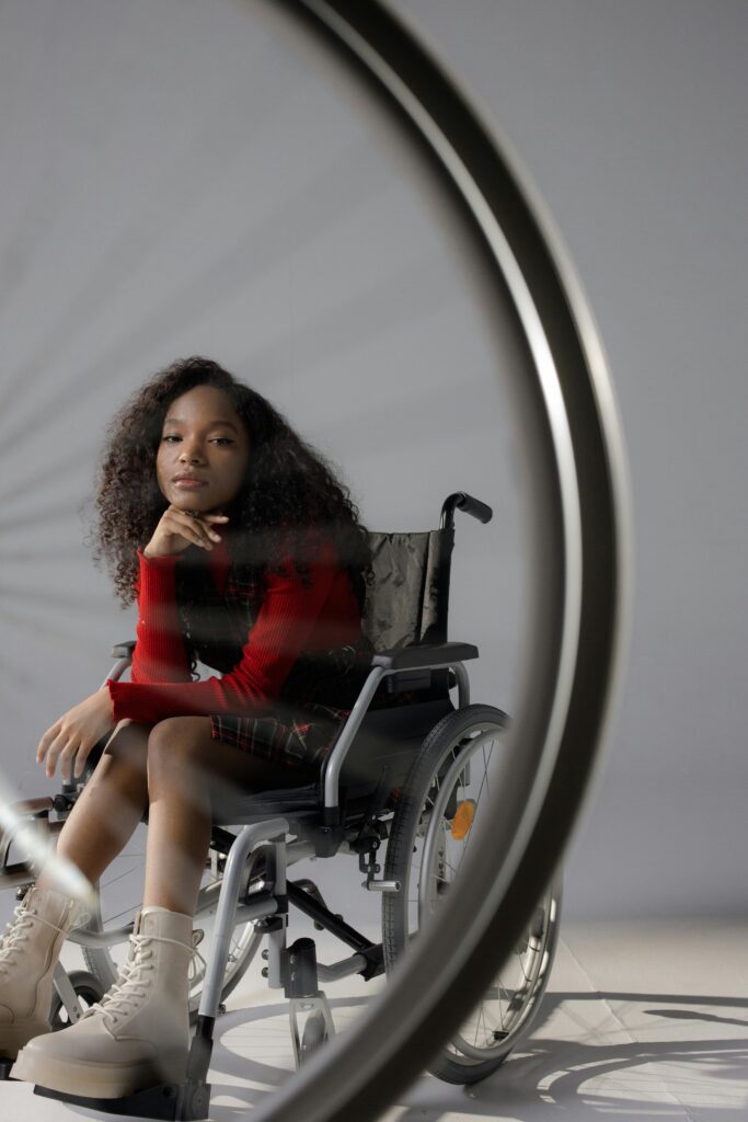 Youthful empowerment and diversity shown through a girl in a wheelchair with afro hair.